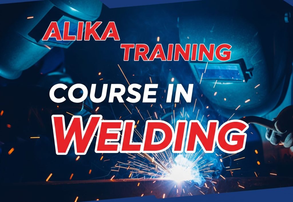  A close-up shot of a student wearing a welding helmet and gloves, expertly joining two pieces of metal with a welding torch. The background shows a modern, well-equipped training workshop.